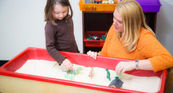 Girl playing in sandbox